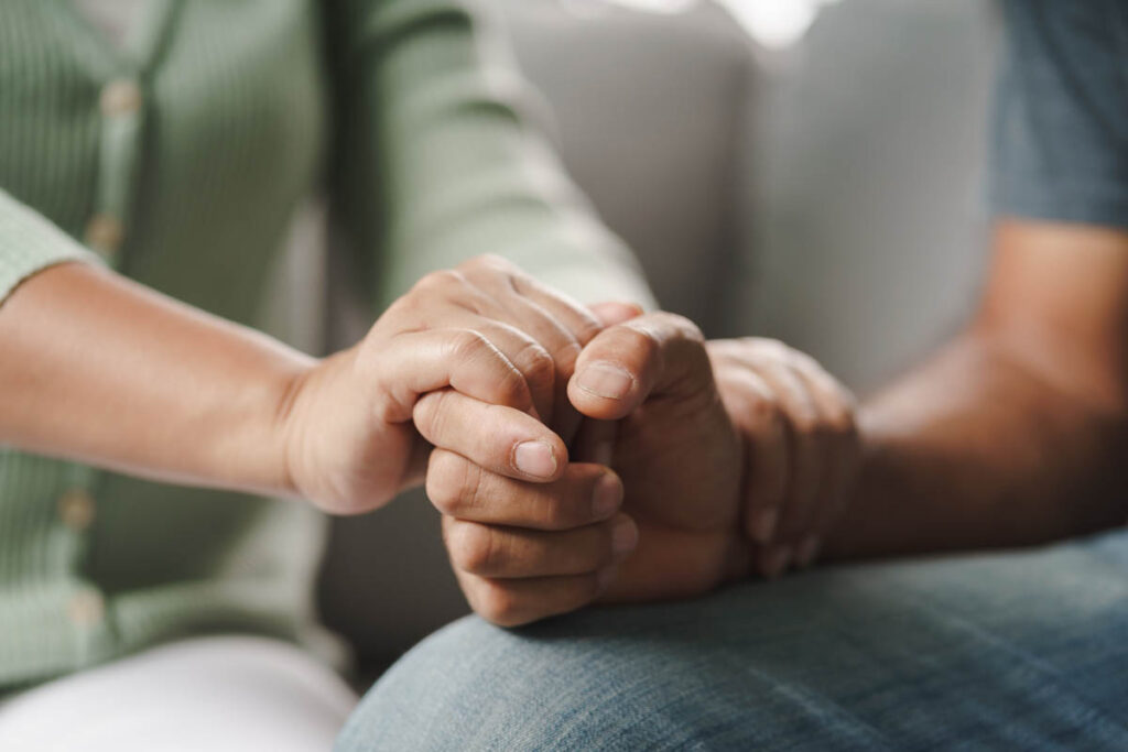 a person holds someone's hand as they explore the benefits of outpatient care