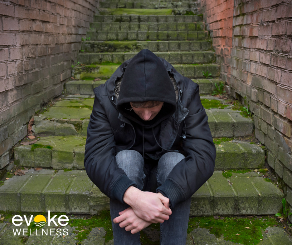 Man sits on stairs recovering from barbiturate addiction